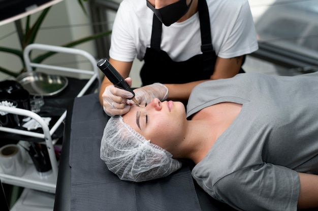 Photo gratuite esthéticienne faisant une procédure de microblading