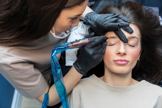 Esthéticienne faisant un traitement des sourcils pour son client