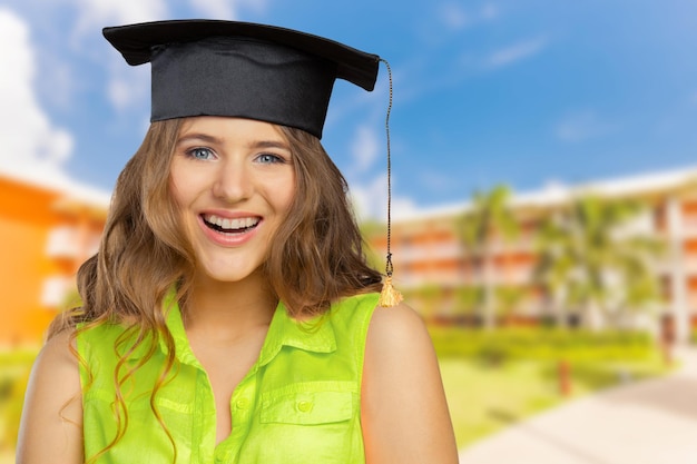 Photo gratuite Étudiant heureux en chapeau de graduation