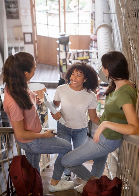 Photo gratuite Étudiants souriants en plein plan discutant