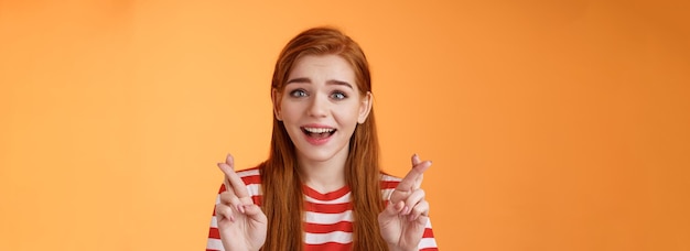 Photo gratuite excité fille rousse pleine d'espoir espoir gagner loterie sourire regard optimiste foi croire que le rêve devient réalité