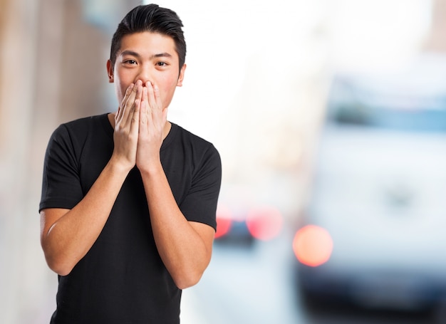 Excité garçon couvrant sa bouche