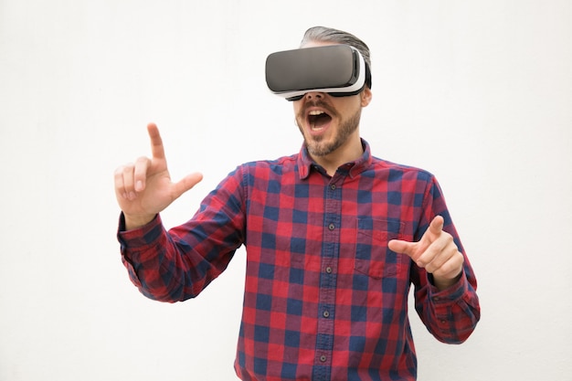 Excité jeune homme expérimenté casque VR