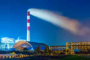 Photo gratuite factory with smoke stack against sky at night