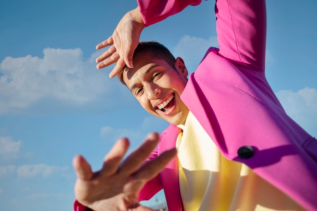 Photo gratuite faible angle de jeune homme dans un champ extérieur