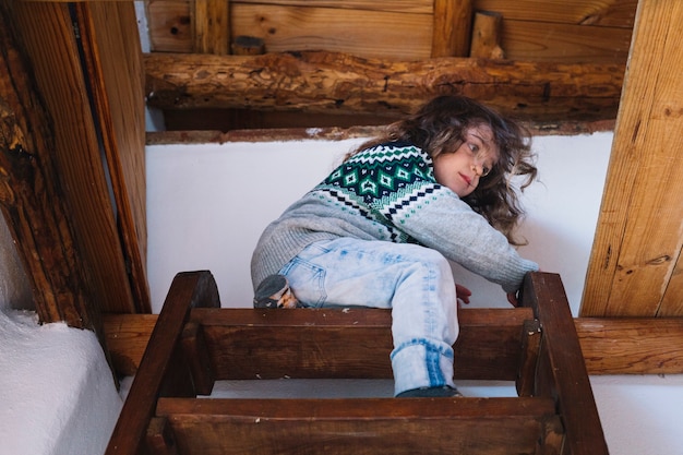 Faible angle de vue d&#39;une fille assise au sommet de l&#39;escalier