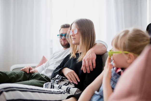 Famille appréciant le film sur le canapé