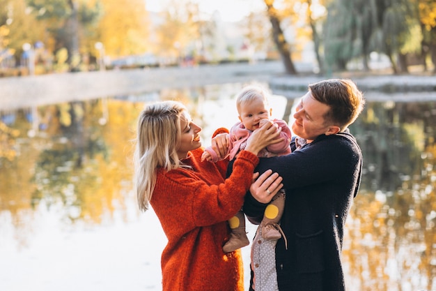 Famille avec bébé fille marchant dans le parc