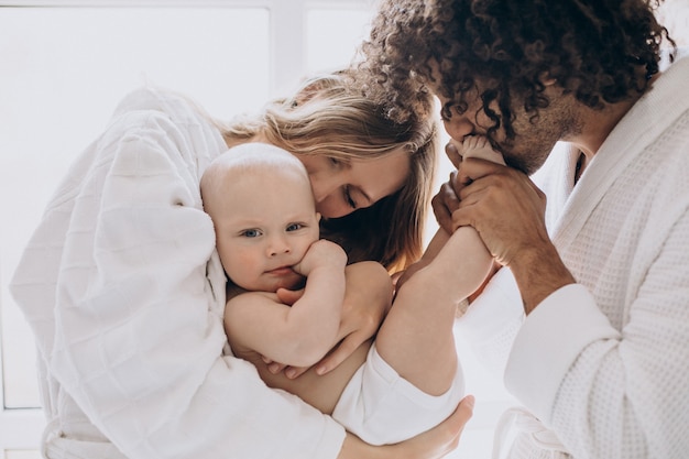 Famille multiculturelle avec leur petit fils s'amusant ensemble