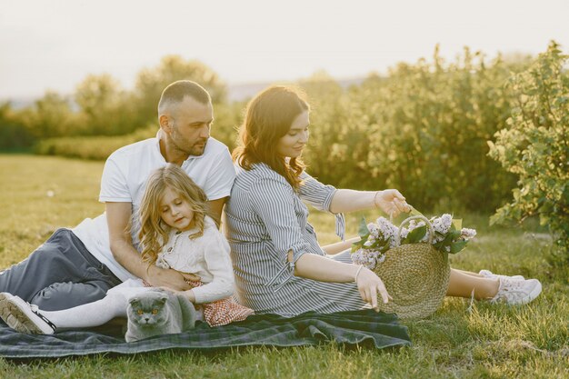 Famille avec petite fille, passer du temps ensemble dans un champ ensoleillé