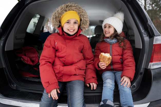 Famille s'amusant pendant le roadtrip d'hiver