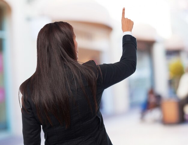 femme d&#39;affaires fraîche pointant vers le haut