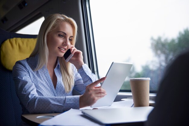 Femme d'affaires parlant par téléphone mobile dans le train