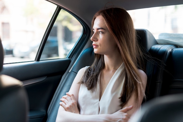 Femme d&#39;affaires posant à l&#39;intérieur d&#39;une voiture