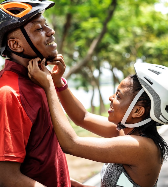 Femme attache un casque de vélo pour son petit ami