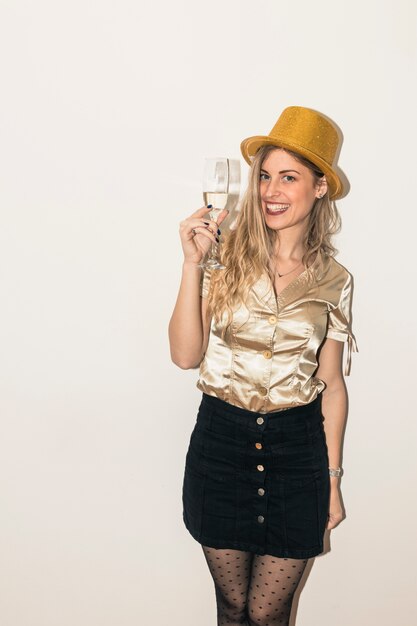 Femme au chapeau avec verre de champagne