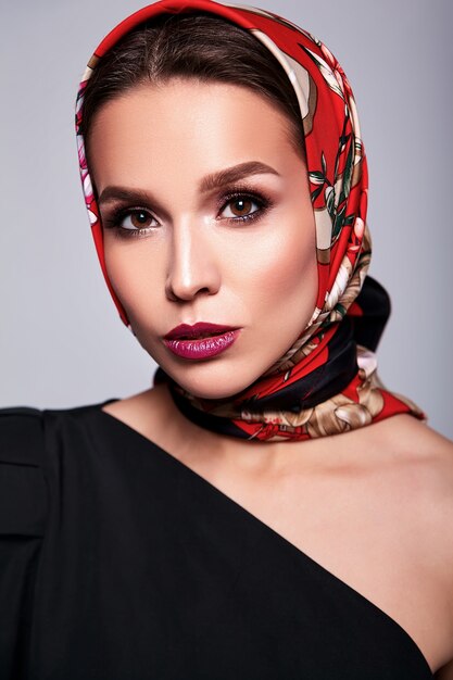 femme brune en costume noir avec maquillage de soirée sur blanc