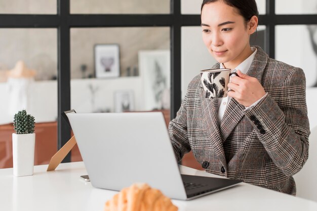 Femme buvant du café tout en travaillant