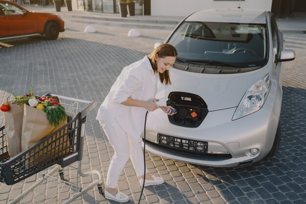 Femme, charger, electro, voiture, électrique, essence, station