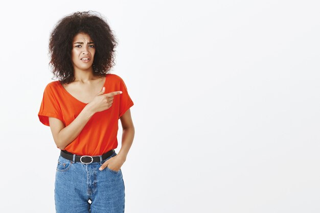 femme avec une coiffure afro posant en studio