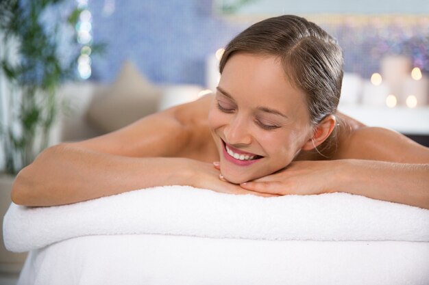 Femme couchée dans la salle de massage sourire