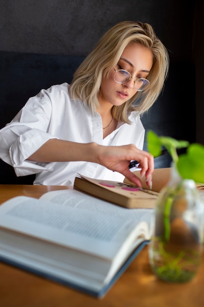 Photo gratuite femme à coup moyen avec journal et livre