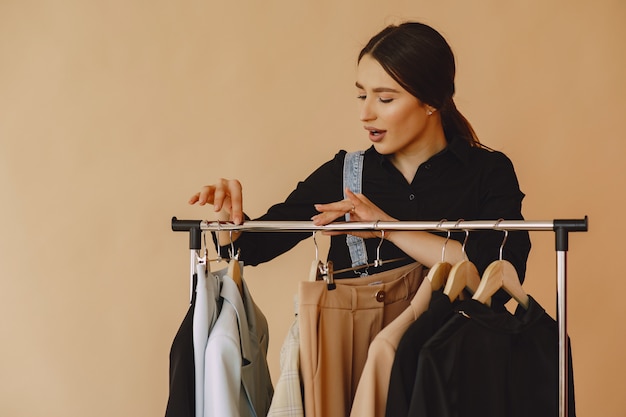 Femme dans un studio avec de nombreux vêtements