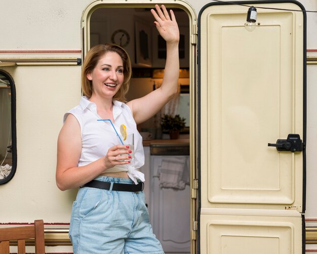 Femme debout tout en tenant un verre de limonade