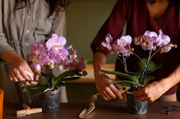 Une femme décore sa maison d'orchidées.