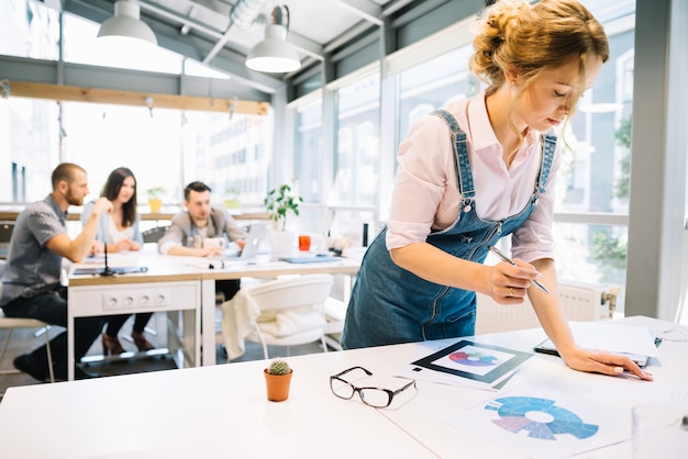 Femme avec des diagrammes au bureau