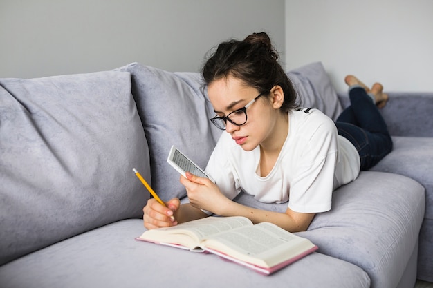 Femme avec e-reader, prendre des notes dans le livre