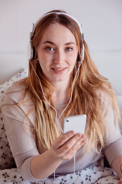 Photo gratuite femme écoutant de la musique à partir de smartphone