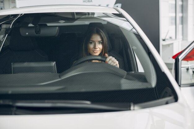 Femme élégante et élégante dans un salon de l'automobile