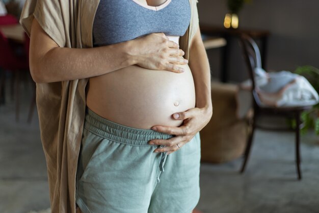 Femme enceinte portant un soutien-gorge et un pantalon