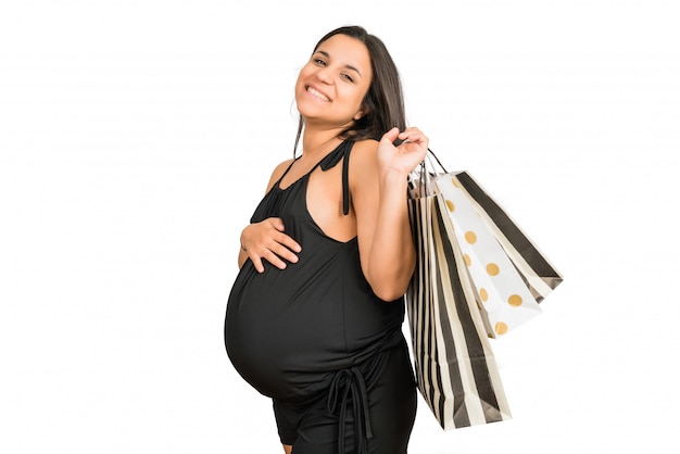 Femme enceinte, tenue, sacs provisions