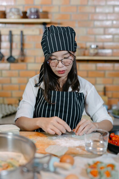 Photo gratuite femme enveloppée dans des boulettes cuisinier de cuisine asiatique.