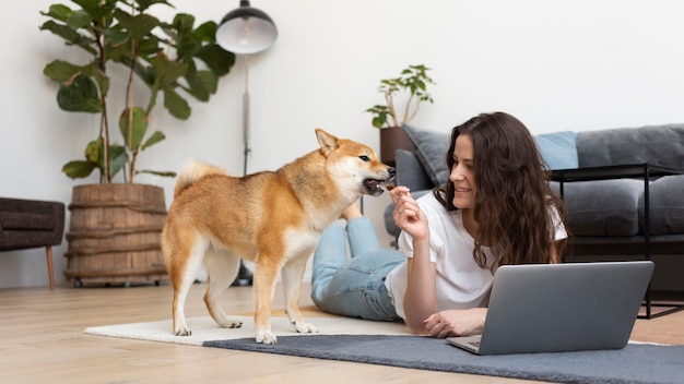 Femme essayant de travailler avec son chien autour