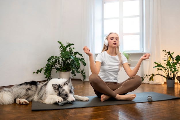 Femme faisant du yoga accompagnée de son animal de compagnie