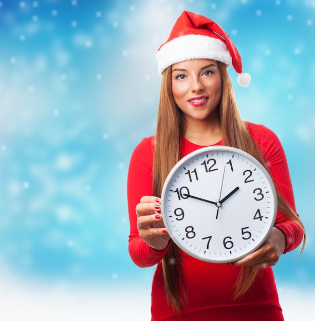 Femme avec une grande horloge tout en neige