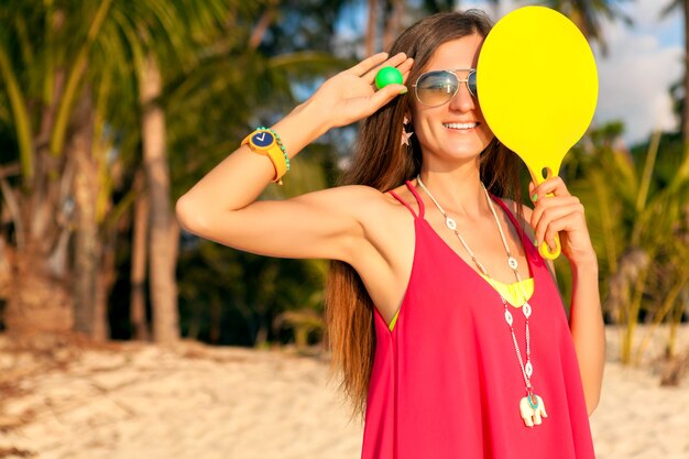 Femme jeune hipster jouant au ping-pong sur la plage tropicale, vacances d'été.