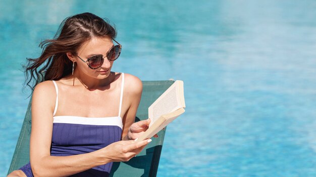 Femme, livre lecture, pose, lit soleil