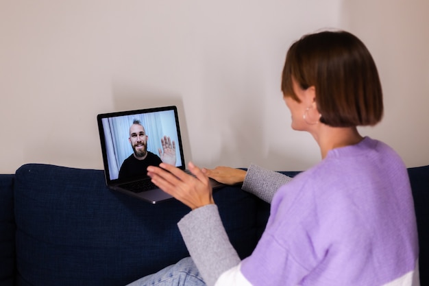 Femme à la maison temps de visage appel vidéo son copain mari amis, bavarder en ligne à partir d'un ordinateur portable