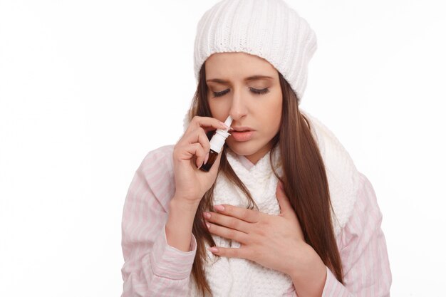 femme malade avec un spray nasal