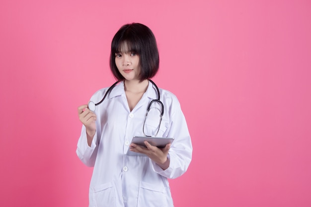 femme médecin asiatique avec blouse blanche sur rose