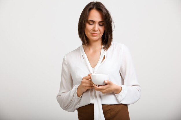 Femme de mode bouleversée réfléchie boire du café, penser