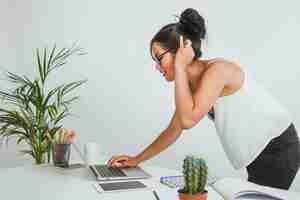 Photo gratuite femme moderne avec un ordinateur portable dans le bureau