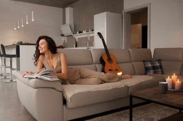 Femme numérique se déconnectant à la maison en lisant un livre