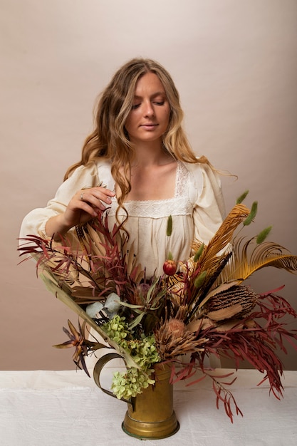 Photo gratuite femme avec des plantes séchées coup moyen