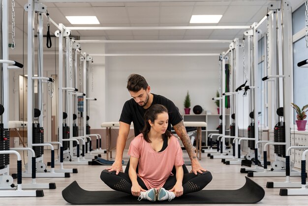 Femme plein coup exerçant sur tapis