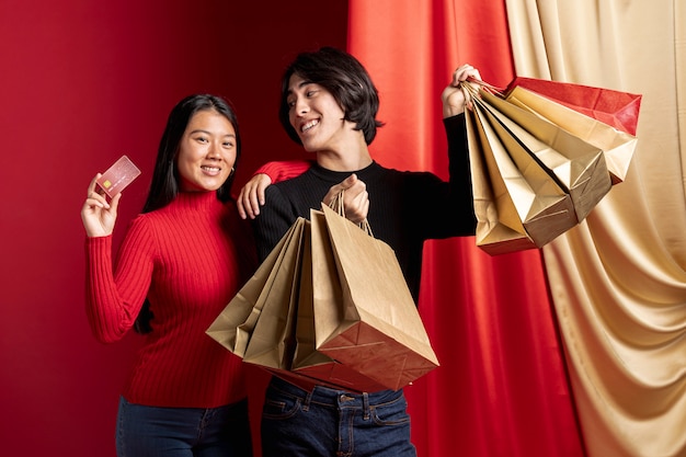 Photo gratuite femme posant avec carte de crédit et homme pour le nouvel an chinois